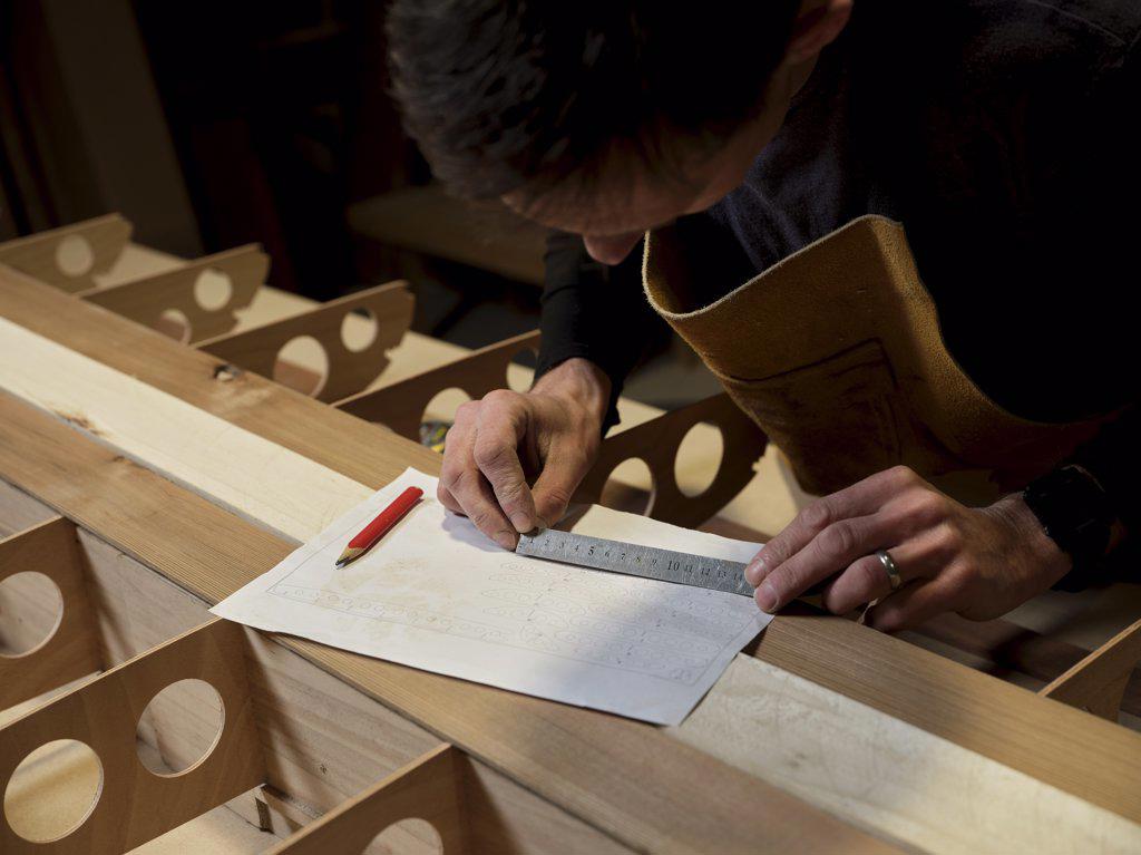 Man using metal ruler in design workshop