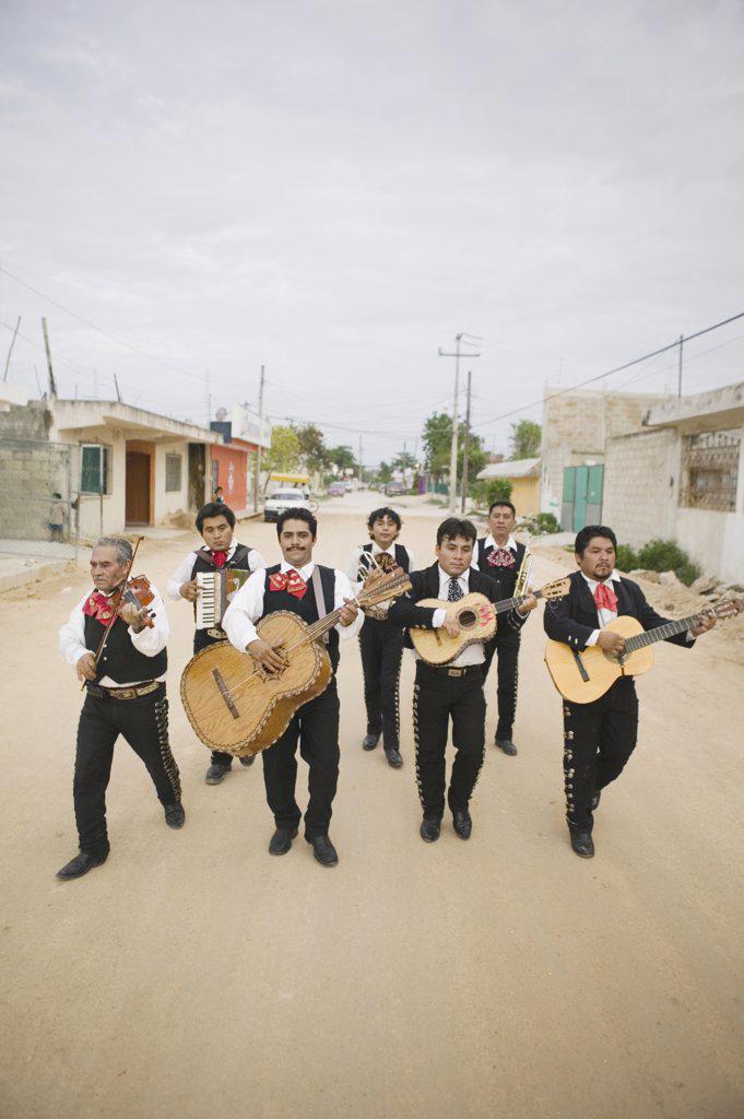 Mariachi band walking and playing their instruments