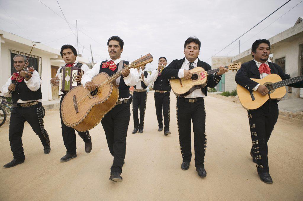 Mariachi band walking and playing their instruments