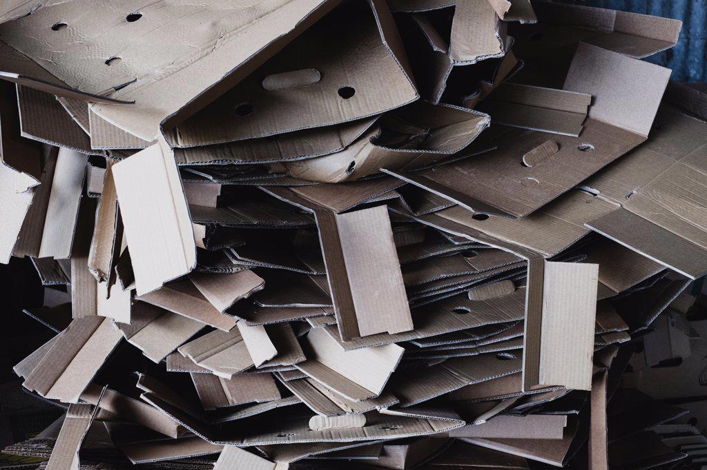 Close up of heap of crumpled cardboard boxes on a farm.