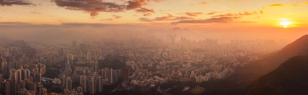 Hong Kong cityscape lit up at dawn.