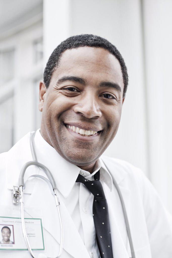Black man doctor in lab coat with a stethoscope.