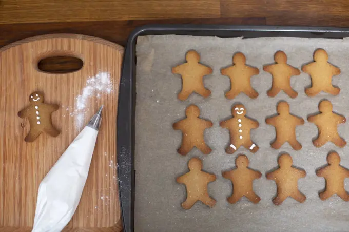 High angle close up of Gingerbread Men on a baking tray.