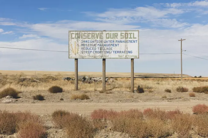 Conserve Our Soil message on a roadside billboard. 