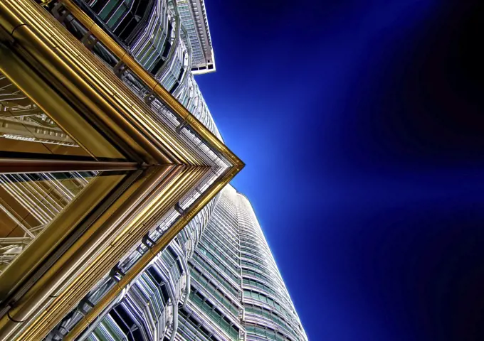 Low angle close up of architectural detail on Petronas Towers in Kuala Lumpur, Malaysia at night.