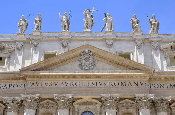 St Peter's Basilica in Rome, Italian Renaissance architecture, and UNESCO world heritage site. Facade with columns, inscription and statues of religious figures on the roofline.
