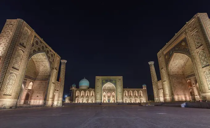 Registan Square at night, with imposing Madrasa buildings, Ulugh Beg Madrasah, Sher-Dor Madrasah and the Tilya Kori Madrasah, Samarkand.