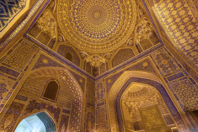Interior, the blue and yellow glazed walls and dome of a Madrasa building in Samarkand.