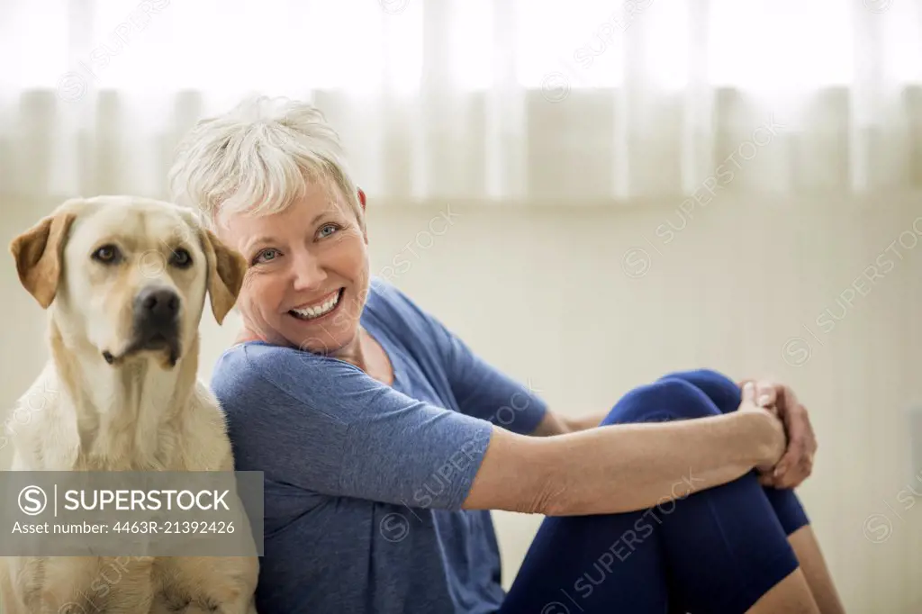 Portrait of a happy mature woman and her pet Labrador.
