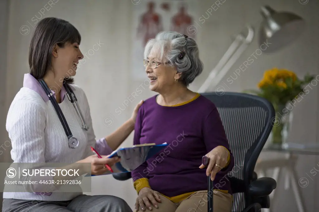 Elderly woman at a medical check-up with her doctor.