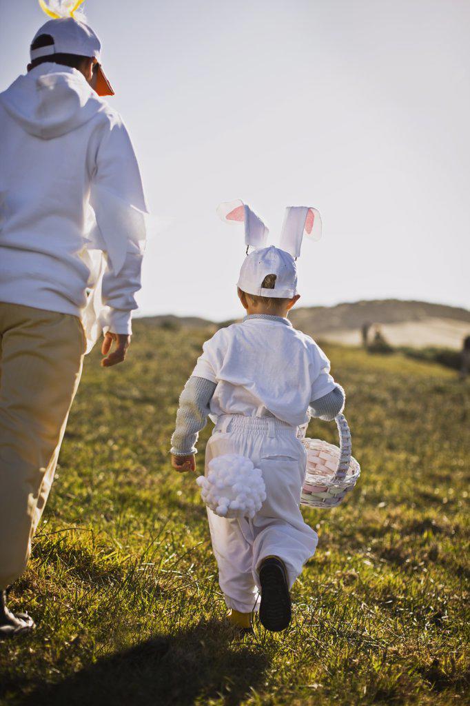 Two brothers in Easter costumes on an Easter egg hunt