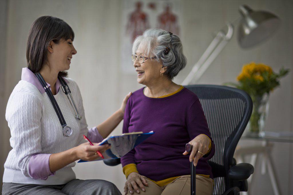 Elderly woman at a medical check-up with her doctor.