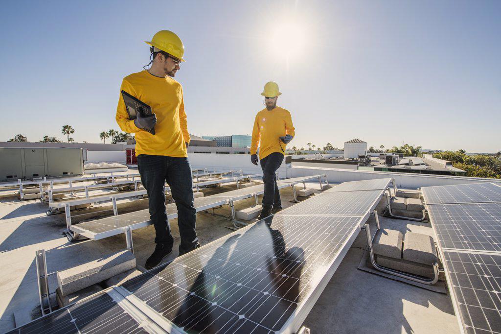 Two Workers Inspect Solar Panel 