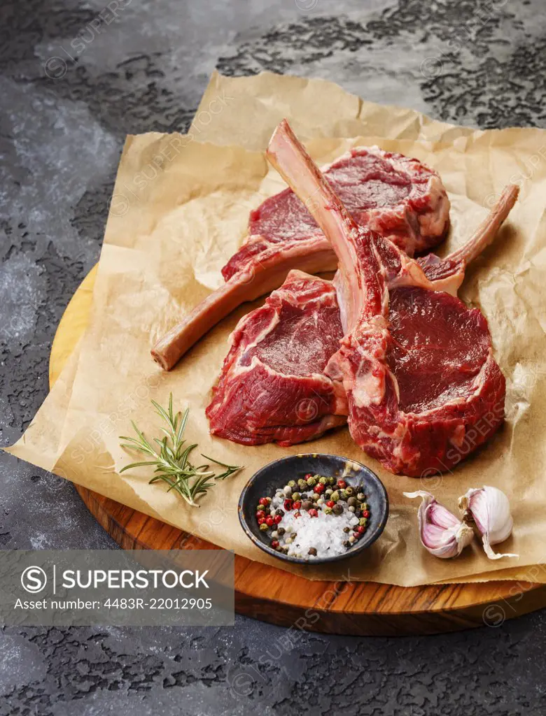 Raw fresh meat Veal ribs Steak on bone and spices on dark background