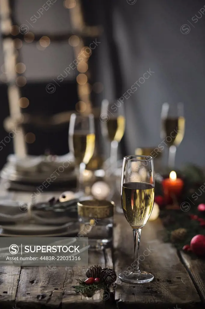 Holiday celebration table setting. Champagne glasses on christmas table setting