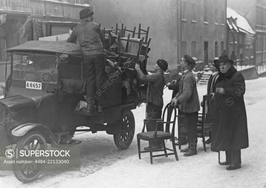 Moving in the 1920s. It's a winter day when the furniture and other things are loaded onto a truck in the central of Stockholm to move to a new location. Sweden 1920s