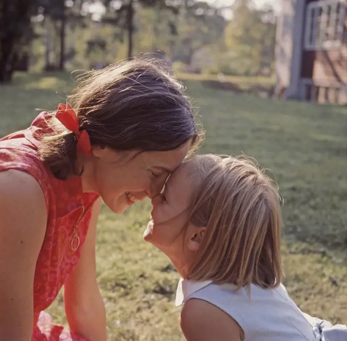 1960s parent. A mother and her daughter play together outside. Sweden 1969
