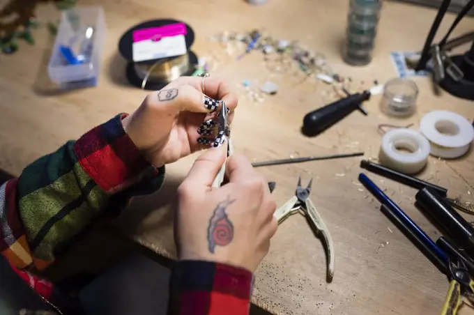 A young women who creates and sells jewlery out of her home