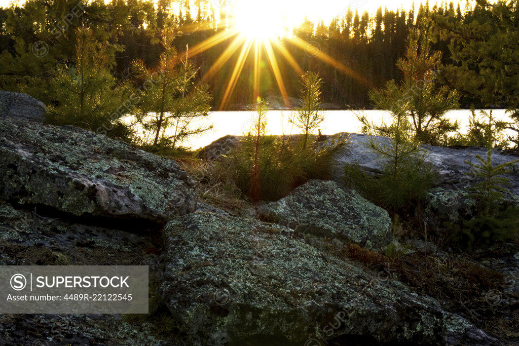 Stock Photo: 4489R-22122545 sunburst over the rocky shoreline of northern Ontario
