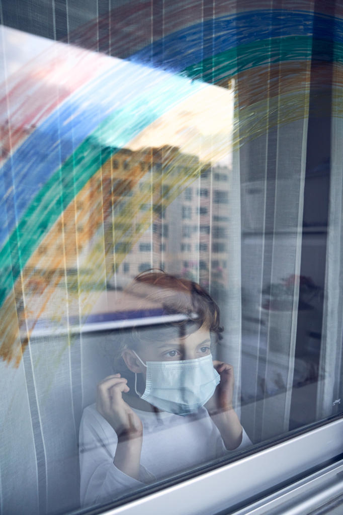 Boy behind window during quarantine