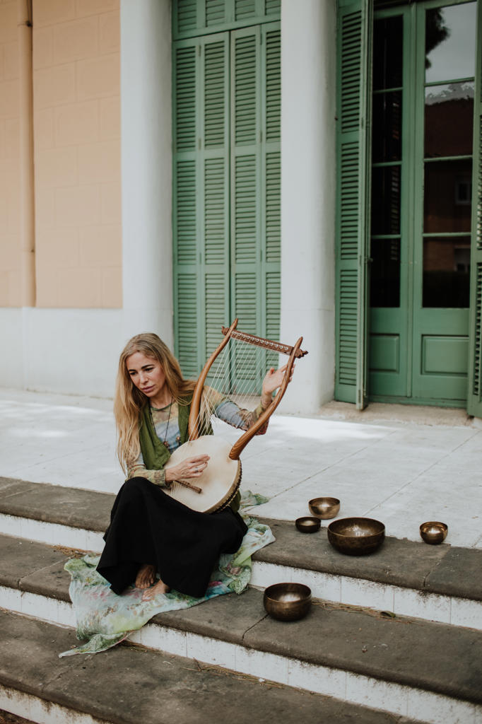 Female playing lyre on steps