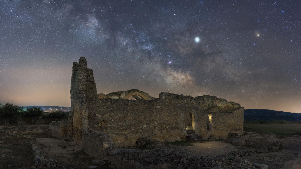 Remains of ancient castle under Milky Way at starry night