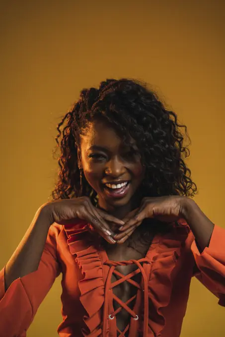 Cheerful black woman posing in studio