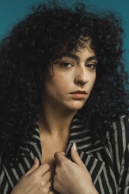 Curly woman posing in studio