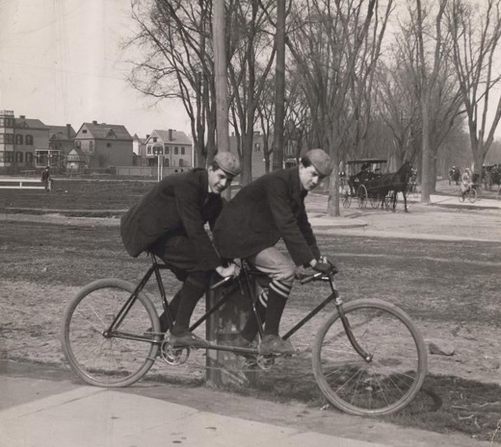Two men cycling on tandem bicycle