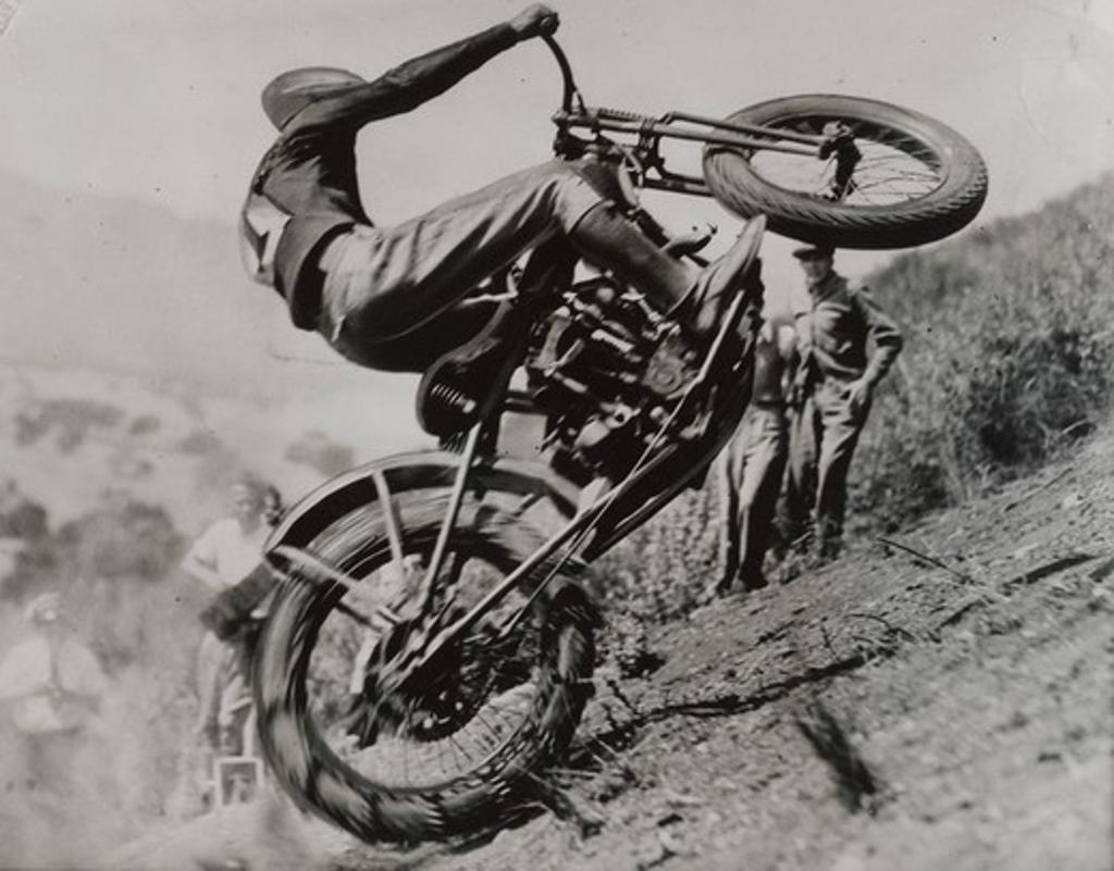 Close-up of biker attempting to ride a hill