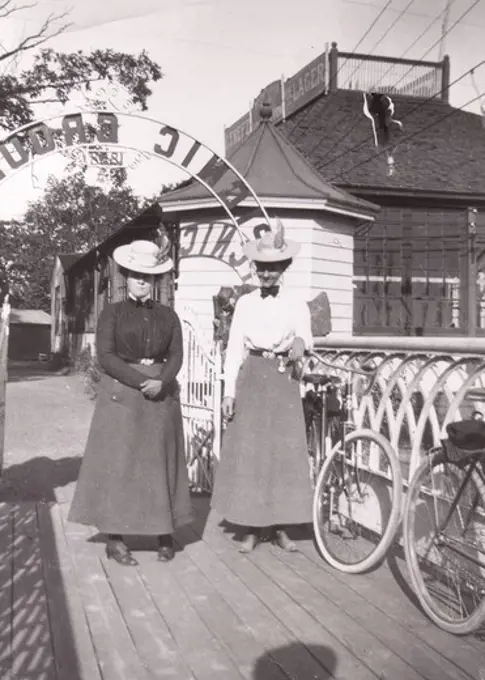 Two women with bicycles aside