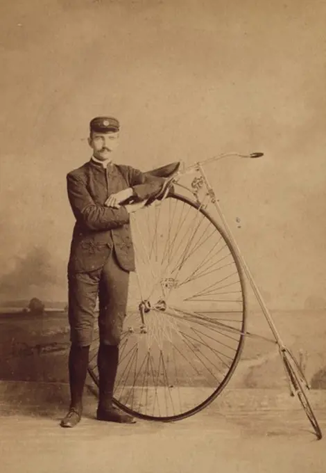 Man posing with his penny farthing bicycle