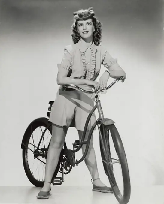 Portrait of teenage girl with bicycle