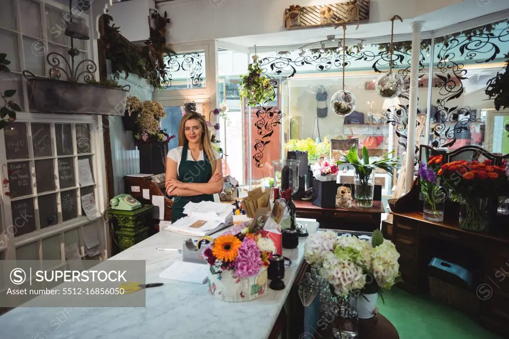Female florist standing with arms crossed in the flower shop