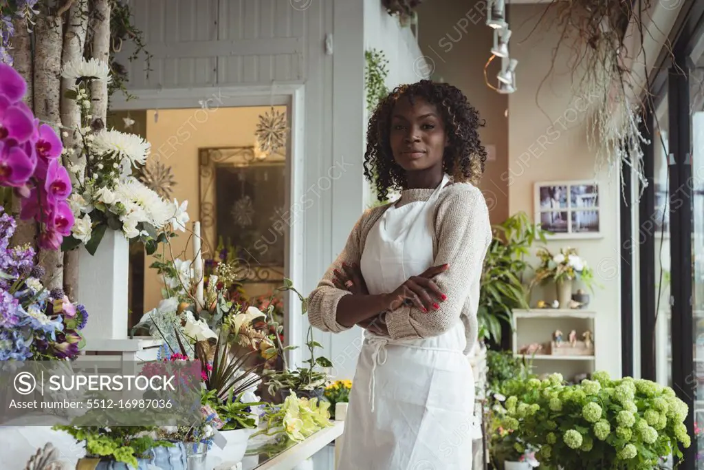 Portrait of female florist with arms crossed at his flower shop