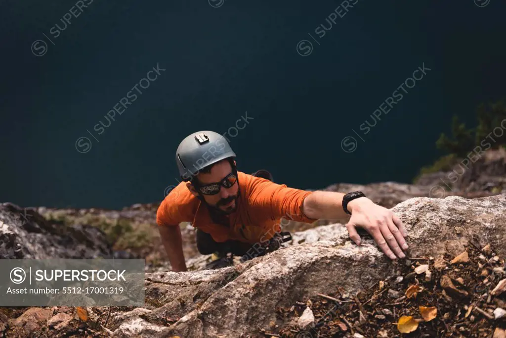 Determined rock climber climbing the rocky mountain