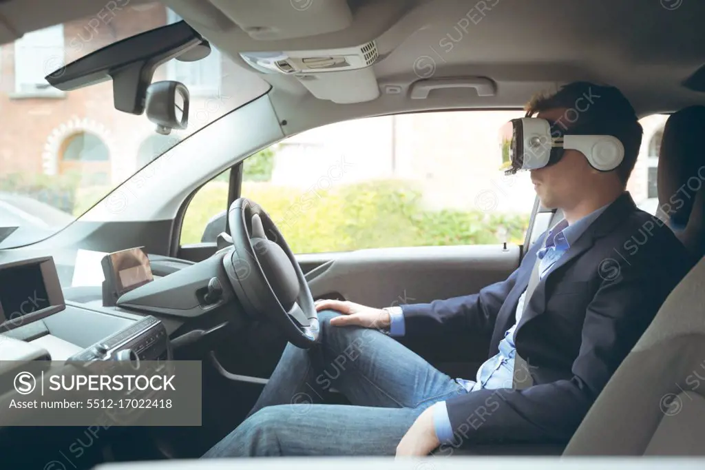 Businessman using virtual reality headset in a car