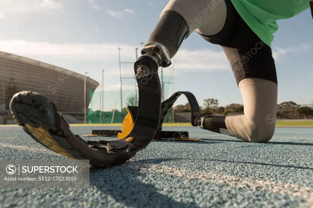 Disabled athletic preparing for the race on a running track