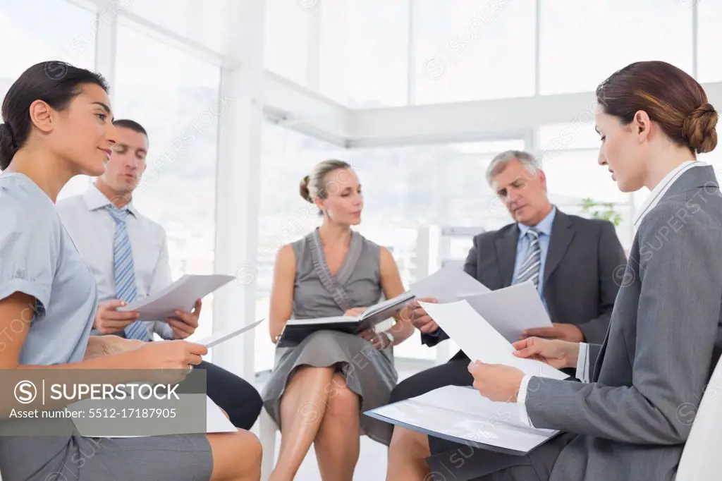 Business team sitting in circle and discussing in the office