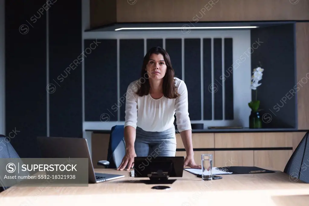 Portrait of caucasian businesswoman standing in meeting room at modern office. business and office concept