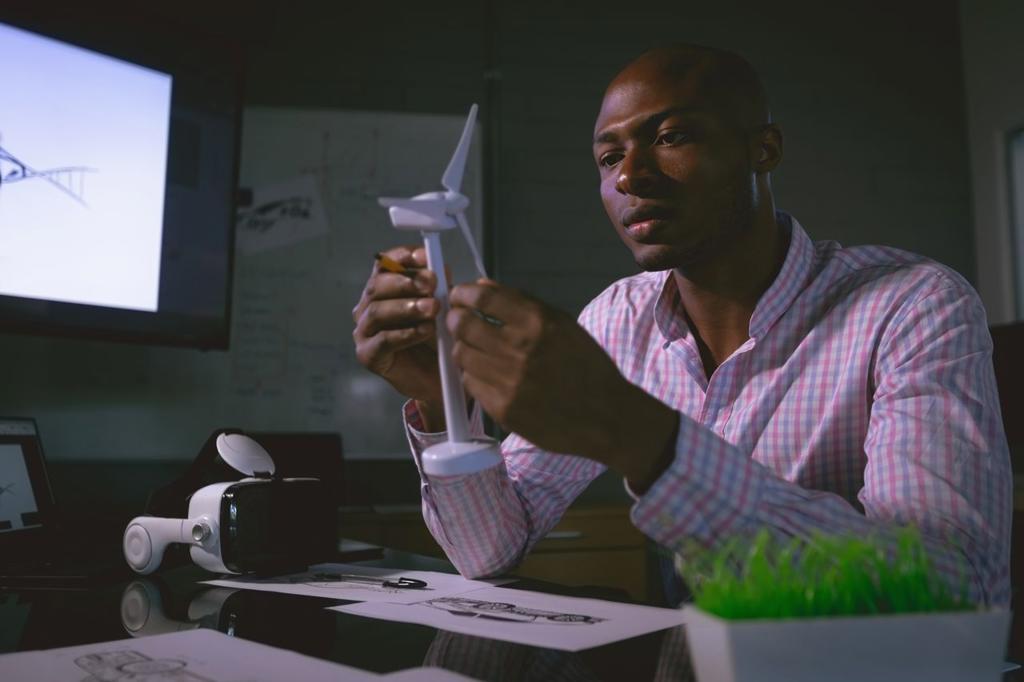 Male executive examining a windmill model in office