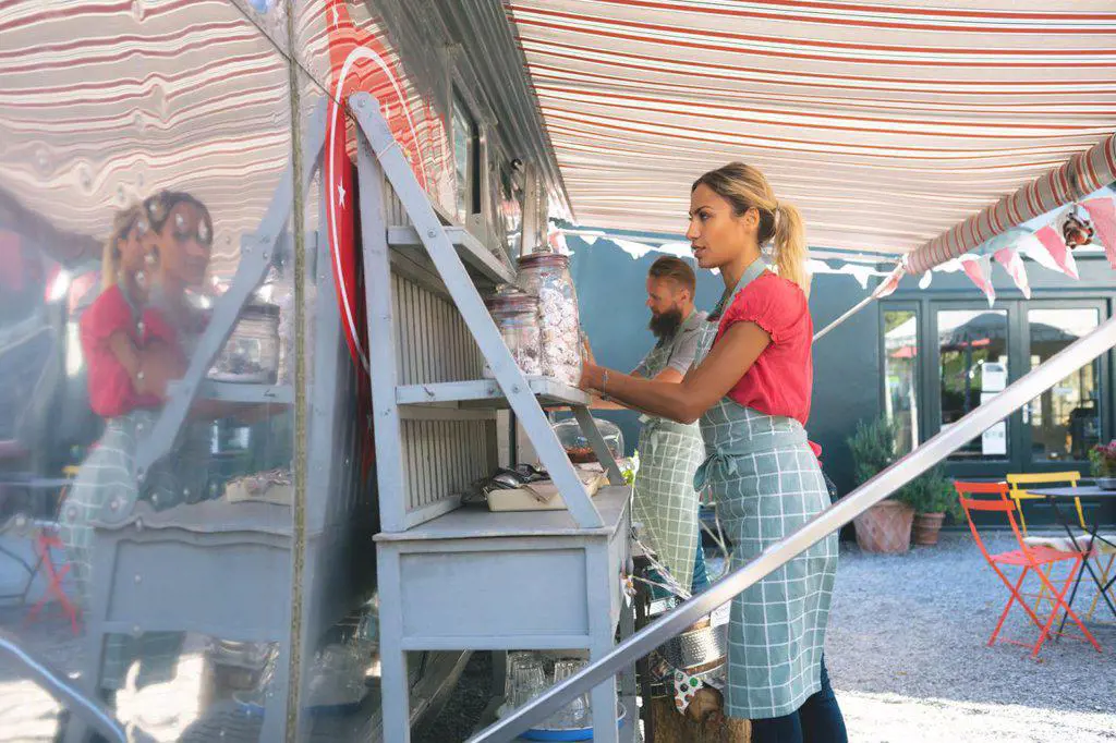 Couple working near together food truck