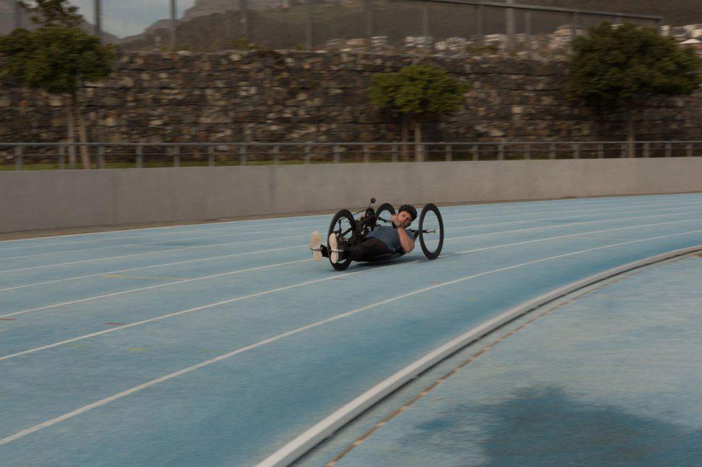Disabled athlete racing in wheelchair on a racing track