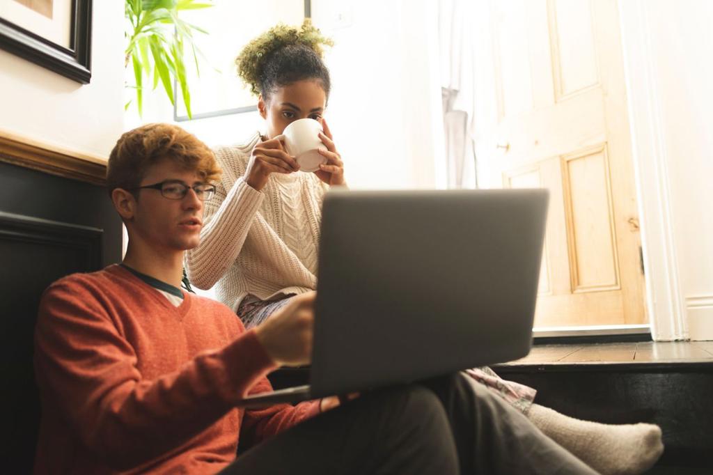 Couple having coffee while using laptop at home