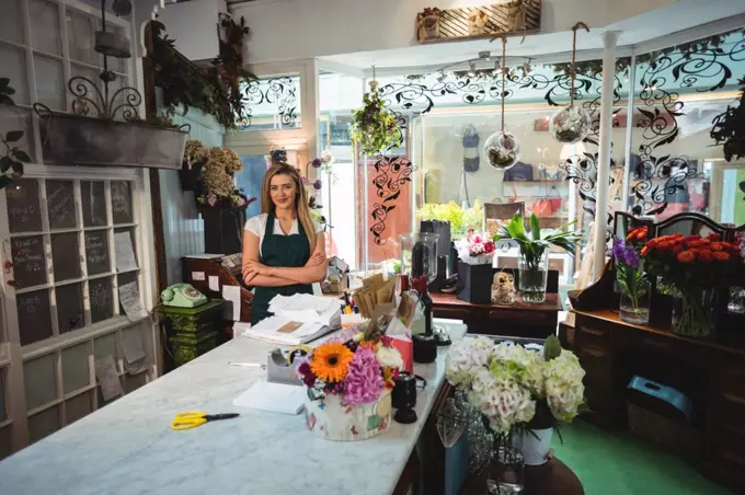 Female florist standing with arms crossed in the flower shop