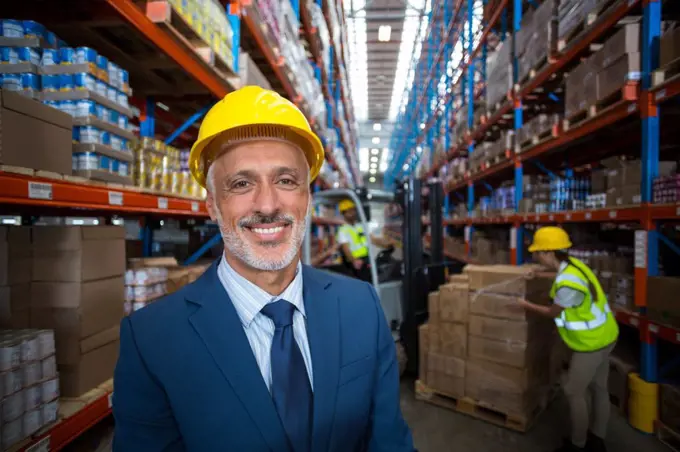 Portrait of warehouse manager smiling in warehouse