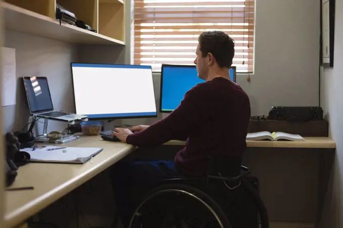 Disabled man working on computer at home