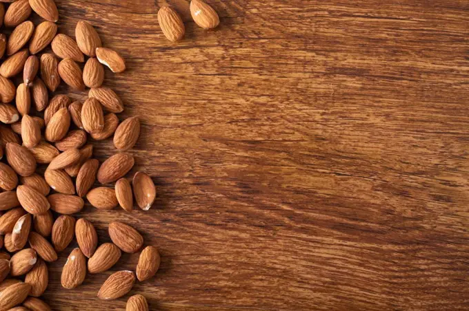Directly above shot of nutritious almonds on wooden table with empty space. unaltered, healthy food, copy space, snack, organic, nut and dried food.