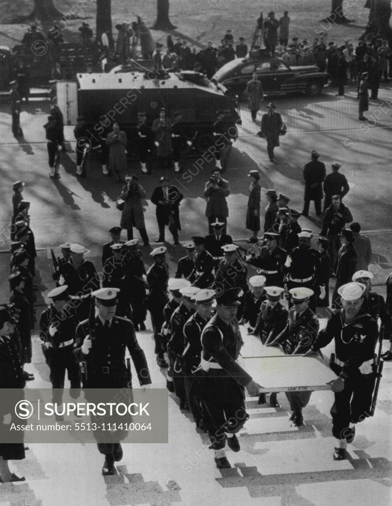 Stock Photo: 5513-111410064 U.S. Constitution Moved To National Archives -- A military escort carries the Constitution of the United States into the National Archives building here today after its transfer from the Library of Congress. In background is the armored car in which the priceless documents were transported under military guard. The documents are encased in six helium-filled cases and will be permanently housed in what is believed to be the World's largest safe. December 13, 1952. (Photo by AP Wirephoto).