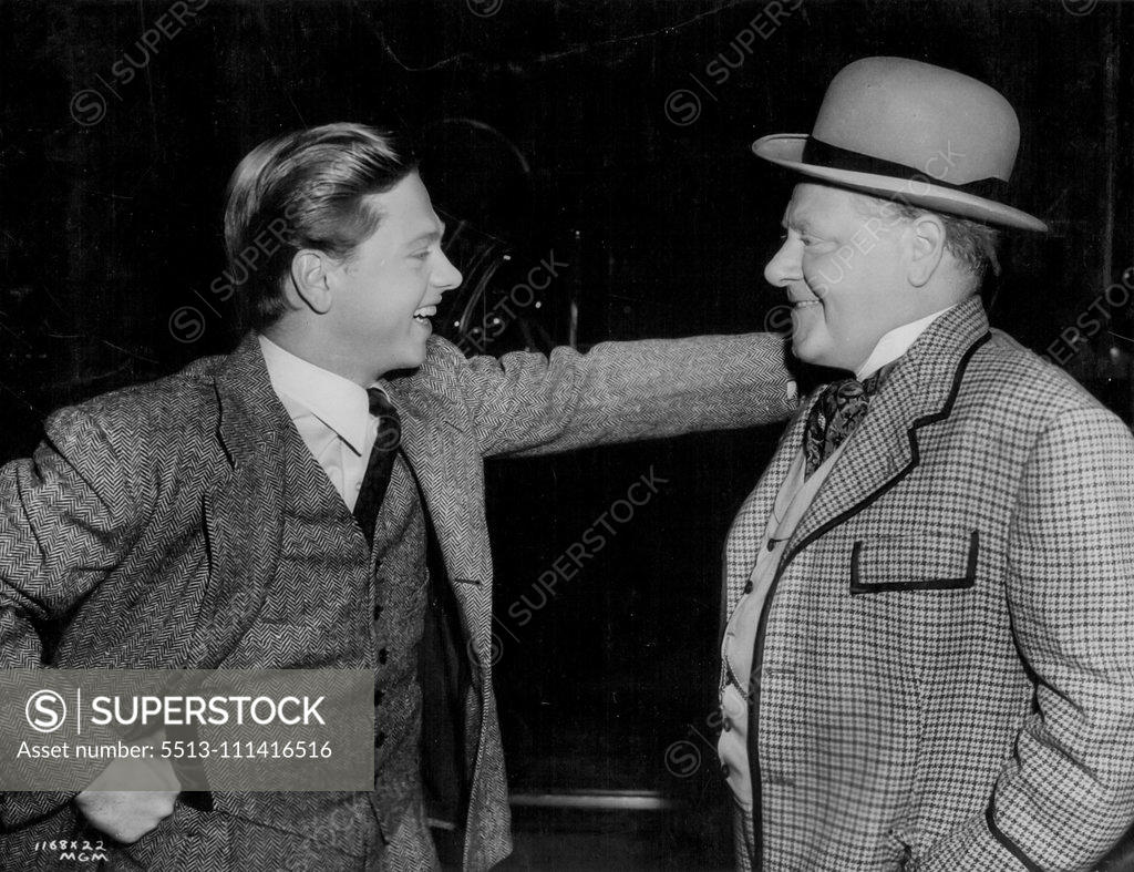 Stock Photo: 5513-111416516 "Hello, Dad"... Mickey Rooney is visited on a set at Metro-Goldwyn-Mayer, by his father, Joe Yule, vaudeville and screen comedian. Yule is costumed for his role in a new Metro-Goldwyn-Mayer film. September 10, 1951.